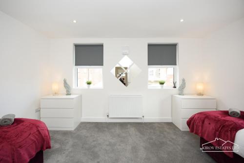 a white room with two beds and two windows at Δ Ares Apartment Δ The Flame of Town in Southampton