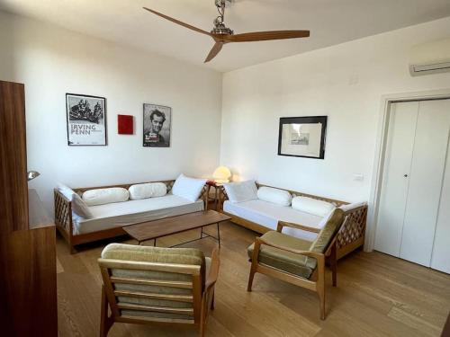 a living room with two couches and a table at Bella Vista apartment in Venice