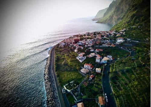 an aerial view of a village on a hill next to the ocean at Casa d' Avó Zeza in Jardim do Mar
