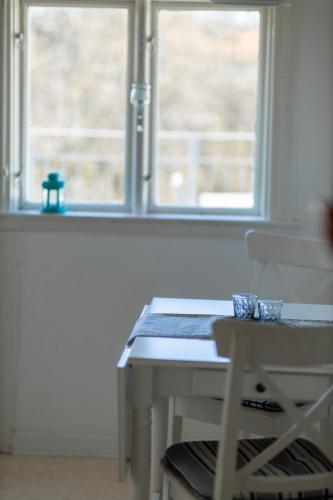 a white desk with a chair in front of a window at Hotell Villa Rönne in Ängelholm