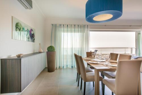 a dining room with a table and chairs at THE ULTIMATE LUXURY, SLIEMA with POOL by Buena Vista in Sliema