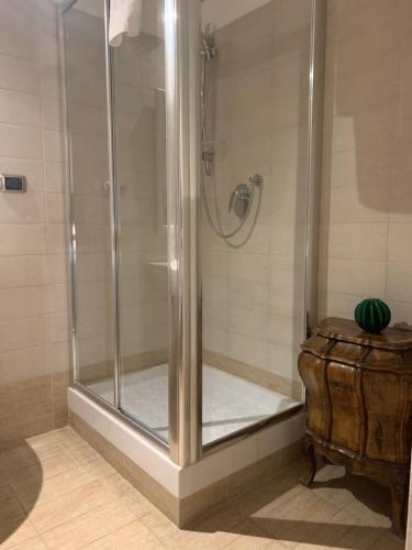 a shower stall in a bathroom with a wooden table at Residenza Tritone Luxury Guest House Trevi Fountain in Rome