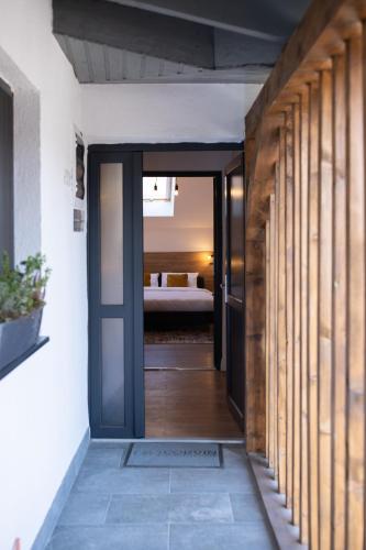 a hallway with a door leading to a bedroom at Corvin Guesthouse in Hunedoara