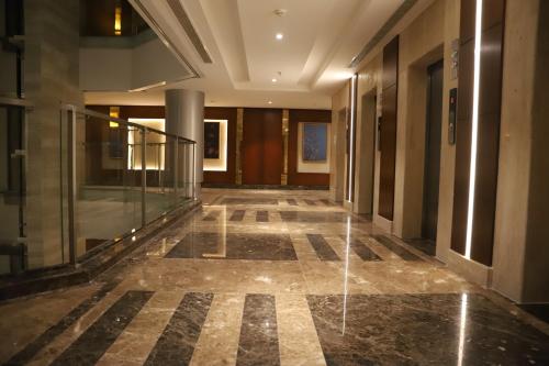 a hallway of a building with a glass walkway at Roots Hotel in Makkah