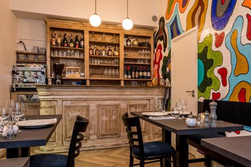 a dining room with two tables and a fireplace at B&B Gracht 62 in Maastricht