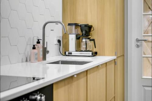 a kitchen counter with a sink and a mixer at Boheme Retreat in Aalborg