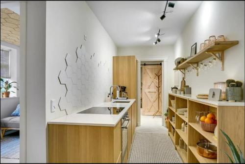 a kitchen with white walls and wooden cabinets at Boheme Retreat in Aalborg