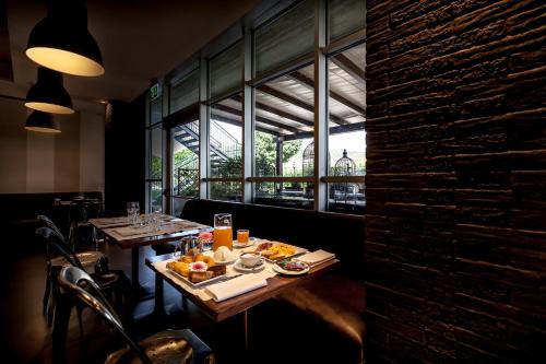 a restaurant with a table with food on it at La Meridiana Bleisure Hotel in Perugia
