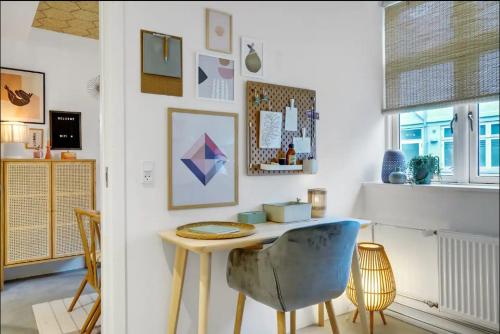 a room with a table and chairs in a room at Boheme Retreat in Aalborg