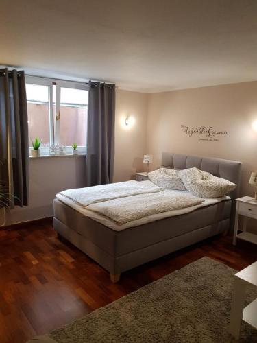 a bedroom with a bed and a window at Ferienappartement am Nadenberg in Lindenberg im Allgäu