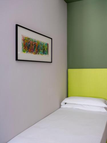a bedroom with a bed and a painting on the wall at Allegroitalia La Spezia 5 Terre in La Spezia