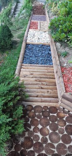a garden with a walkway with rocks and plants at Chaty Pohoda na Soláni in Velké Karlovice
