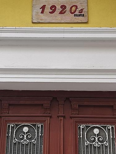 a sign above the door of a building at 1920s Rooms in Kalamata