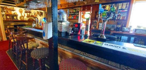 a kitchen with a bar and a table with drinks on it at Sportsmans Valley Hotel in Liskeard