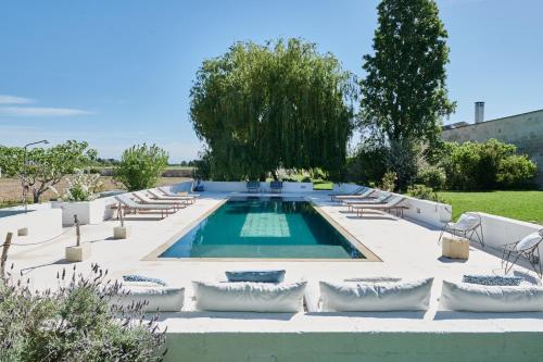 a swimming pool in a yard with lounge chairs at Masseria Prosperi in Alimini