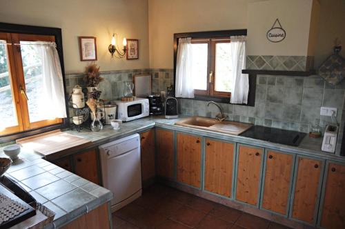 a kitchen with a sink and a counter top at Port del Comte a pie de pistas in La Coma i la Pedra