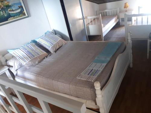 a white bed in a room with a bunk bed at Maison en front de mer, à Saint-Pierre-la-Mer in Fleury