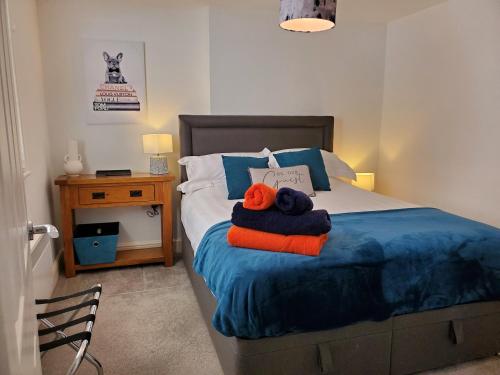 a bedroom with a bed with towels on it at Ipswich Town Centre Apartment 5 in Ipswich