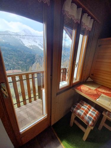 a room with a balcony with a view of a mountain at Romantic Spa in Venas