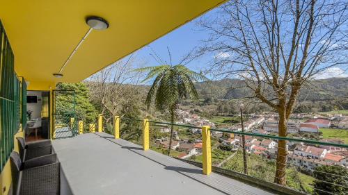 a balcony with a view of a city at Casa Varanda das Furnas in Furnas