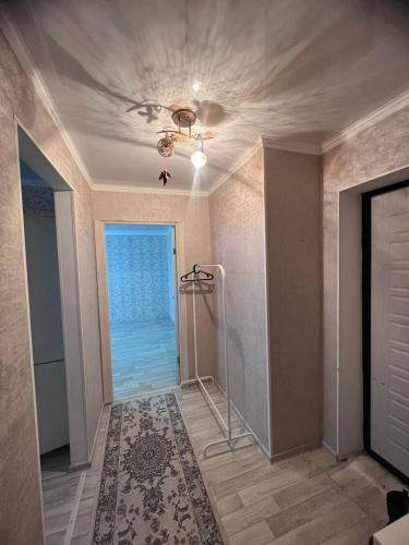 a room with a ceiling fan and a walk in shower at 2-х комнатная квартира напротив аквапарка in Aktobe