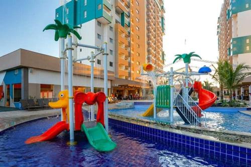 a swimming pool with a playground in a mall at Olímpia Park Resort in Olímpia