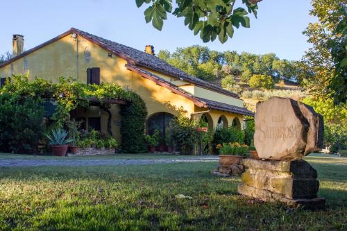 a house with a sign in front of it at B&B Salvarosa in Fano