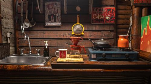 a kitchen counter with a sink and a stove at Cabaña Eco amigable en medio de la montaña. in Pastales