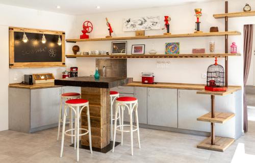 a kitchen with a counter and stools in a room at Scarpapè in Giubiasco