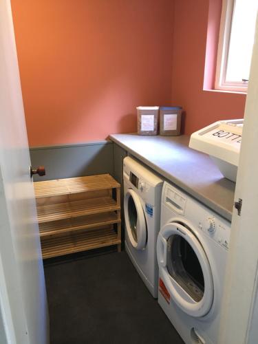 a laundry room with a washer and dryer at Camusmore House in Aviemore