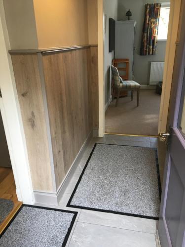 a door leading into a room with a hallway at Camusmore House in Aviemore