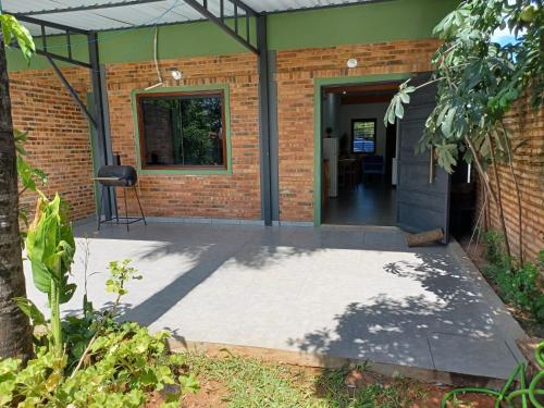 an open door of a brick house with a patio at Casa Naranja in San Lorenzo