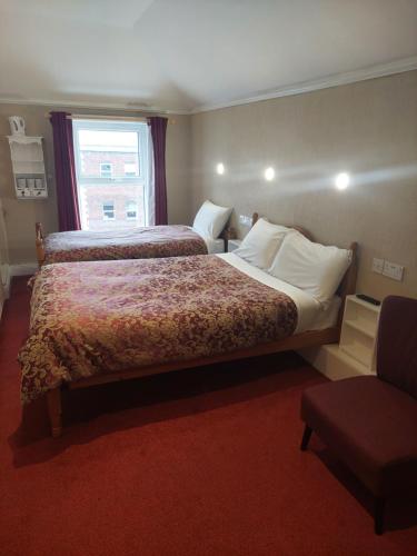 Uma cama ou camas num quarto em Parkway Guesthouse