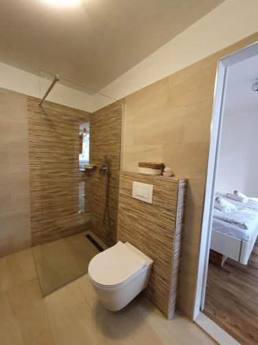 a bathroom with a toilet and a shower at Harmony - Your Cozy Retreat a Short Walk from the Center in Portorož