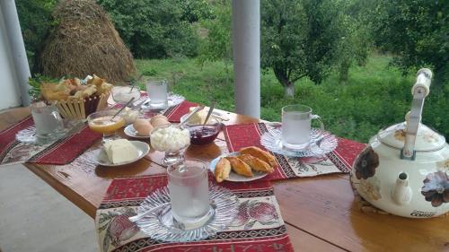 a picnic table with food and drinks on it at AMOJ B&B and Guest house in Alaverdi