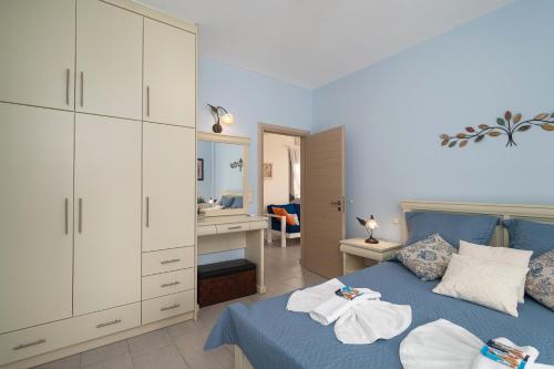 1 Schlafzimmer mit einem blauen Bett und einem Badezimmer in der Unterkunft Villa Jodi in Pitsidia