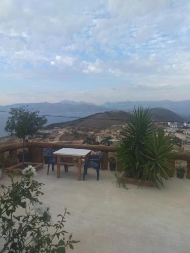 a table and chairs on a patio with a view at Grand Seaview Apartments in Ksamil