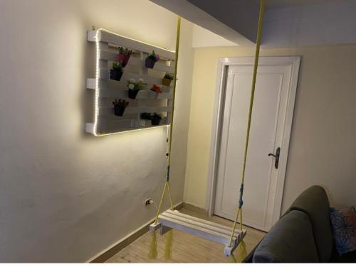 a room with a wall with a swing and a door at شالية 180م بالروف 180م قرية هليوبيتش الساحل الشمالي للايجار للعائلات فقط in Dawwār ‘Abd al Qādir Qāsim