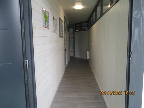 an empty hallway with a hallway leading into a room at Le Pijolin in Saint-Justin