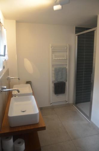 a bathroom with a white sink and a window at Casa Lario in Naggio