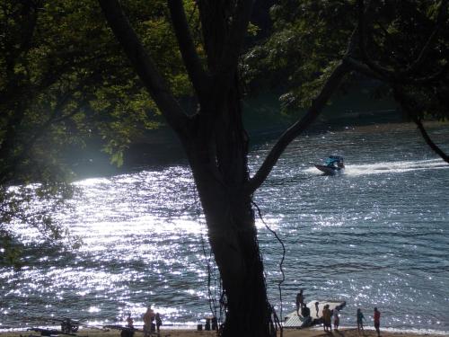 a person on a paddle board in the water at Recanto Apoena in Santa Isabel