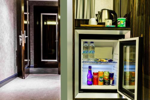 an open refrigerator with bottles of water and soda at Euro Design Hotel in Istanbul