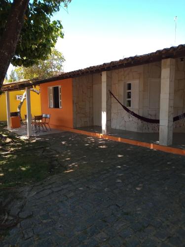 a building with a patio in front of it at Pé de mato chalé in Estância