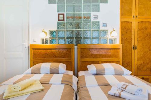 two beds sitting next to each other in a bedroom at Holiday home in Crikvenica 39416 in Crikvenica