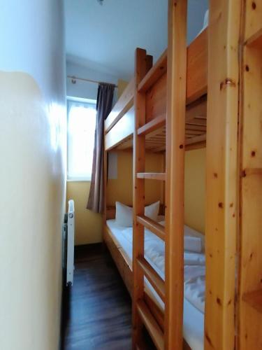 a room with two bunk beds and a window at Pension Bomätscher in Königstein an der Elbe