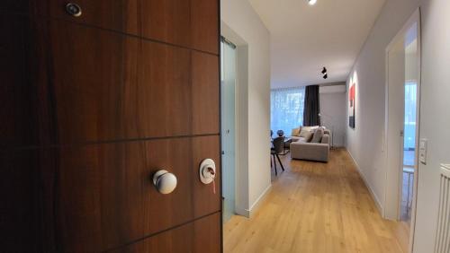 a hallway with a wooden door and a living room at Vivo Apartments in Athens