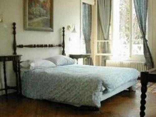 a bedroom with a bed and a window at Chalet Du Bel Event in La Chapelle-sur-Dun