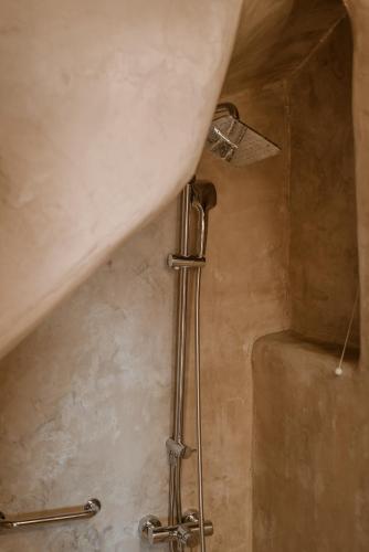 a shower in a bathroom with a sink at Alika Resort in Álika
