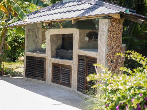 a bird house with a roof on top of it at Amani Paradise - Luxury Villas in Diani Beach