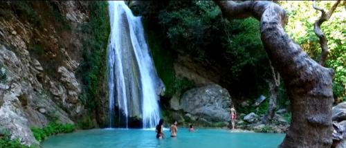 a group of people swimming in a waterfall at Super renovated maisonette - Σούπερ ανακαινισμένη μεζονέτα in Filiatra